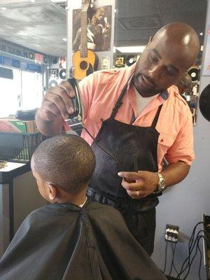 Master barber Bernard doing an excellent job with my grandson.