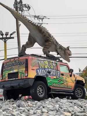 Dinosaur thing on top of van in middle of course.