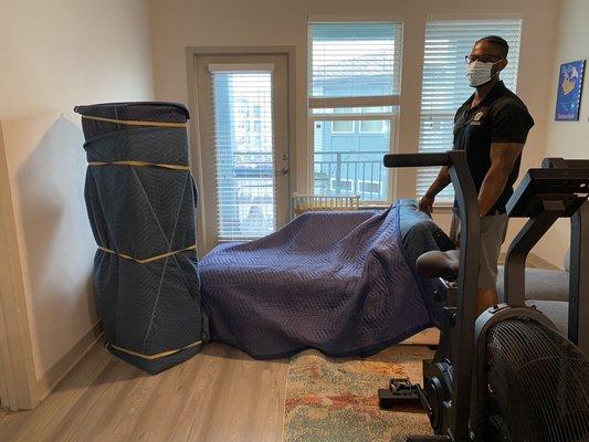 Bryant packing up furniture and gym equipment from 3rd floor apartment.