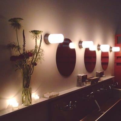 Changing room sinks and mirrors with fresh flowers on display