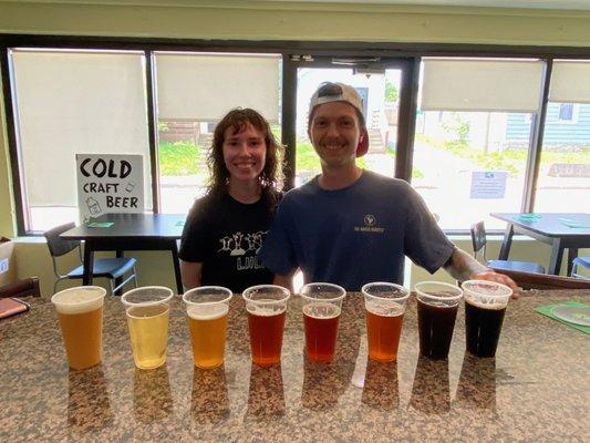 Two friends out sharing a flight of beer samples.