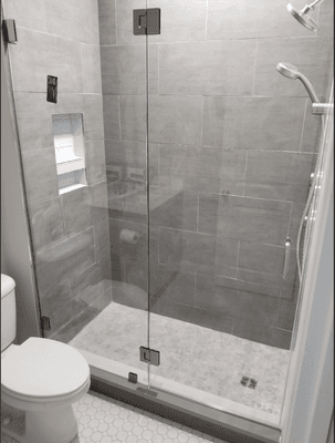 Custom bathroom renovation. This is a tub to shower conversion with glass tile and a frameless shower door upgrade.