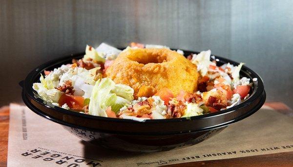 Incredible Steakhouse Salad topped with a Thick Cut Onion Ring