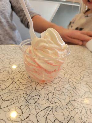 Vanilla ice cream with strawberry swirl topping.