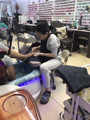 Kathy, the Owner finishing a pedicure