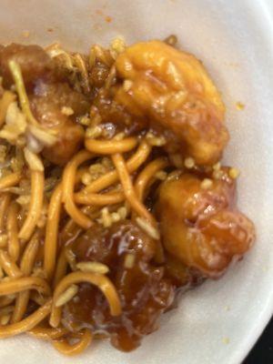 A bowl with chow mein and fried rice and orange chicken. The bowl was $10