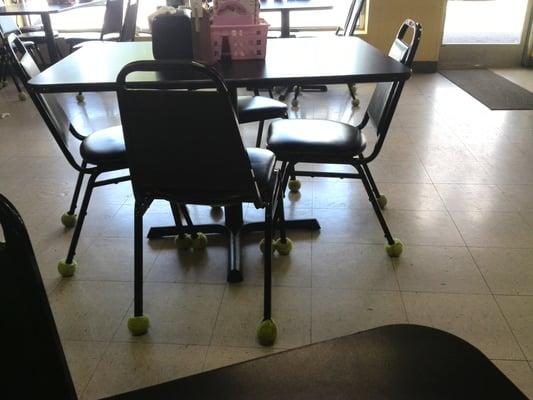 Tennis balls on the chair legs for silent and easy gliding.