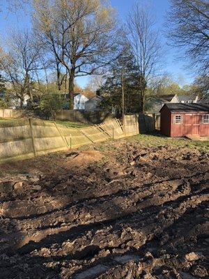 Deep damage to the side yard around where trees were removed. Also fence continues to lean