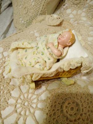 A baby doll in a cradle in good condition