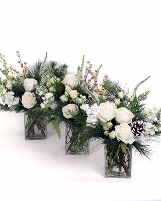 White Christmas-This arrangement captures the beauty of a snowy winter day with pristine white roses and spray roses, and delicate stock