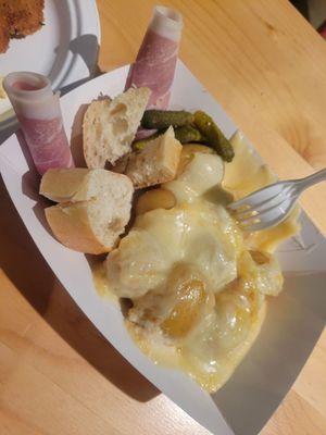 Raclette over potatoes and prosciutto