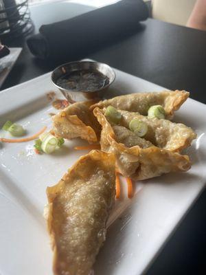 Half eaten plate of gyoza.