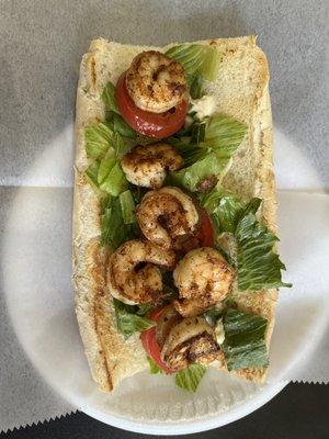 Blackend Shrimp Po Boy. The bread is Leidenheimer and it comes with mayo, lettuce, tomato, and pickles.