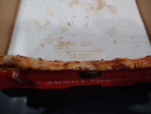 That's the thickness or should I say thinness of the pizza. It's like 1/8 of an inch or even thinner. Taste like frozen bad pizza