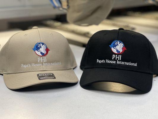 PHI logo on khaki and black caps.