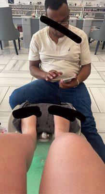 (Playing in his phone mid-pedicure)