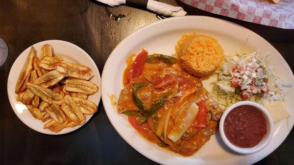 Stewed pork chop, rice, salad, beans, cheese, and fried bananas