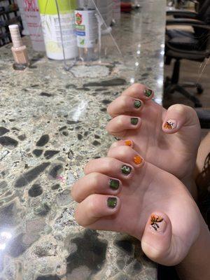 Halloween nail art on tiny fingers.