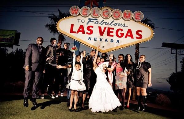 The entire party jumped simultaneously in front of the iconic Las Vegas sign at dusk.