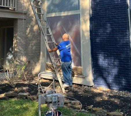 Employee Working on Exterior Painting for Residential Home in Kingwood, TX