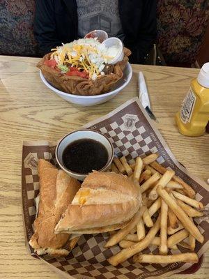 Taco salad and toasted roast beef sandwich with melted cheese and auju dipping sauce and bottomless fries.