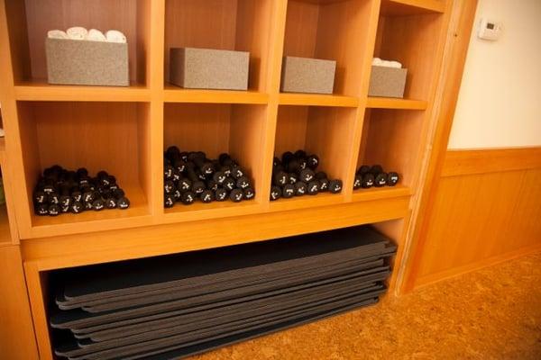 Handweights, mats, yoga straps and hand towels are stored in cubbies at barre3 Atlanta - South Buckhead.