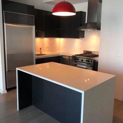 Calacatta Vicenza quartz kitchen countertops, full backsplash, and island with waterfall