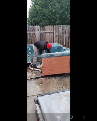 Cutting the hot tub into pieces