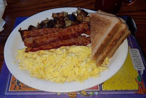 2 scrambled eggs, home fries with onions, bacon an wheat toast. Coffee.