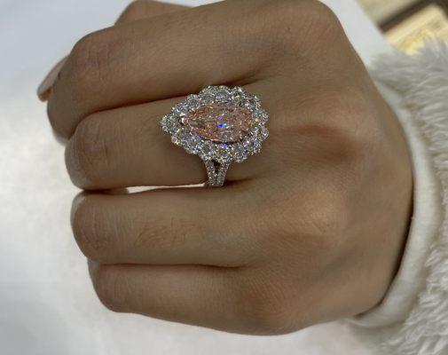 3 carat pear shaped diamond Fancy Intense Orangey Pink . It's a custom made micro pave set diamond ring .