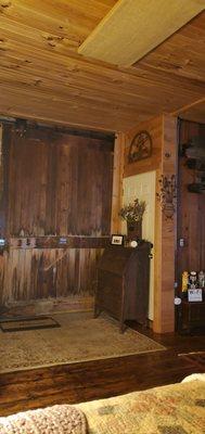 The barn door pulls out and goes over your double doors.