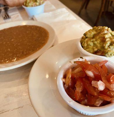 Refried beans, heaping serving of fresh homemade guacamole, and mild salsa