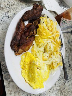 Scrambled eggs, bacon, and hashbrowns. It was all right.