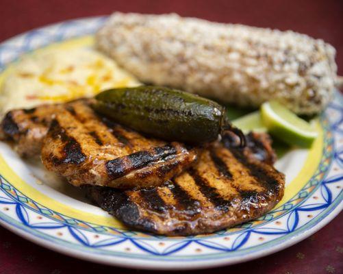 Infused Jalapeno pork chops . comes with potatoes and choice of side - delish