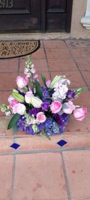 Centerpiece with pink Roses and stock, purple hydrangeas, stock, snaps, and lysanthus, white lilies