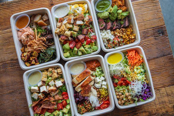 A selection of our bowls - Melrose, Cobb, Vegan Cobb, Southwest, Mediterranean, and a custom salmon bowl.