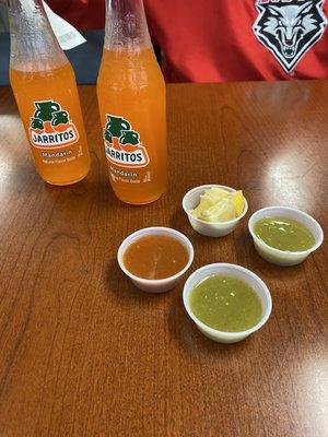 A couple of mandarin Juaritos and their salsas