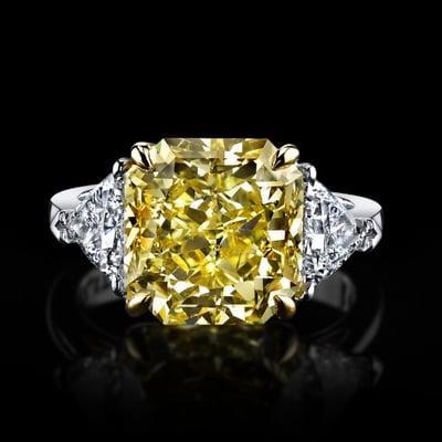 Radiant Cut Vibrant Yellow Natural Diamond with Exquisite Trillion side diamonds set in Platinum and 18K yellow gold.