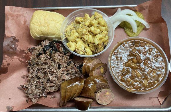 Chopped brisket , Smoked Mac and Cheese with brisket, cowboy beans, jalapeños and cheese sausage with a sweet biscuit.