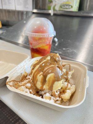 Funnel cake with powdered sugar, cookie butter drizzle and vanilla ice cream.