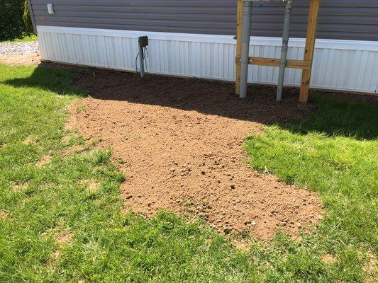 Screened top soil filled in trenches left by electrical contractor.