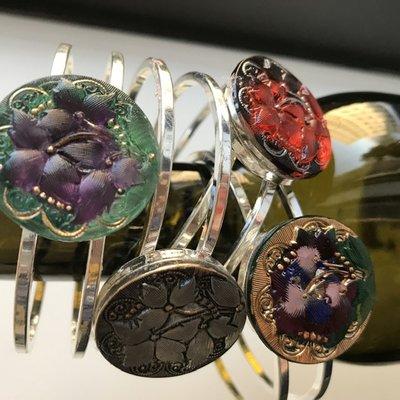 Button bangles - all featuring the same button mold, but showing a fraction of the varieties available thanks to the finishing artists.