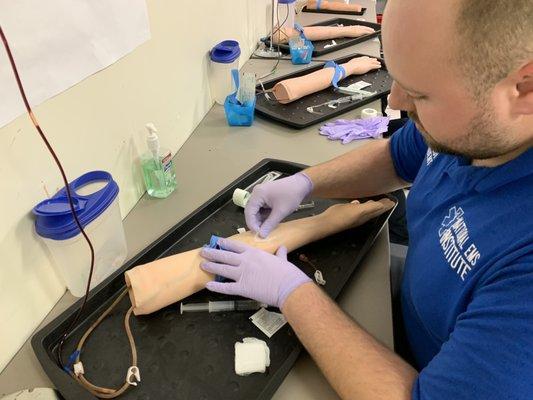 Paramedic student mastering their IV skills.