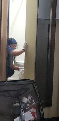 A very  Hotel worker cleaning poop off the walls & toliet after I found a nice maintenance guy in the hallway 2 help