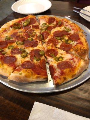 large pepperoni and jalapeño pizza