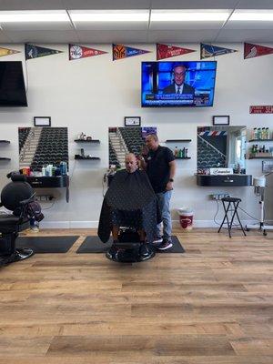 Ramiro is giving a client a fade, and shave.