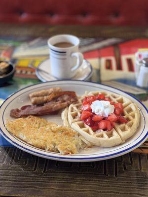 Waffle, coffee, bacon, sausage and hash browns.