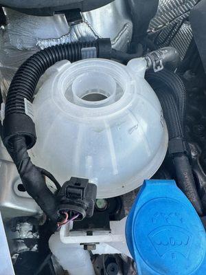 Empty and clean coolant reservoir