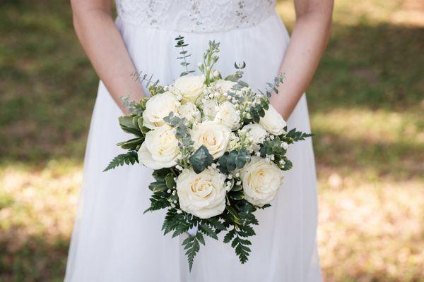 wedding bouquet with white roses, baby's breath, and eucalyptus leaves