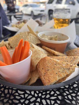 Roasted garlic hummus with toast points and tortilla chips.